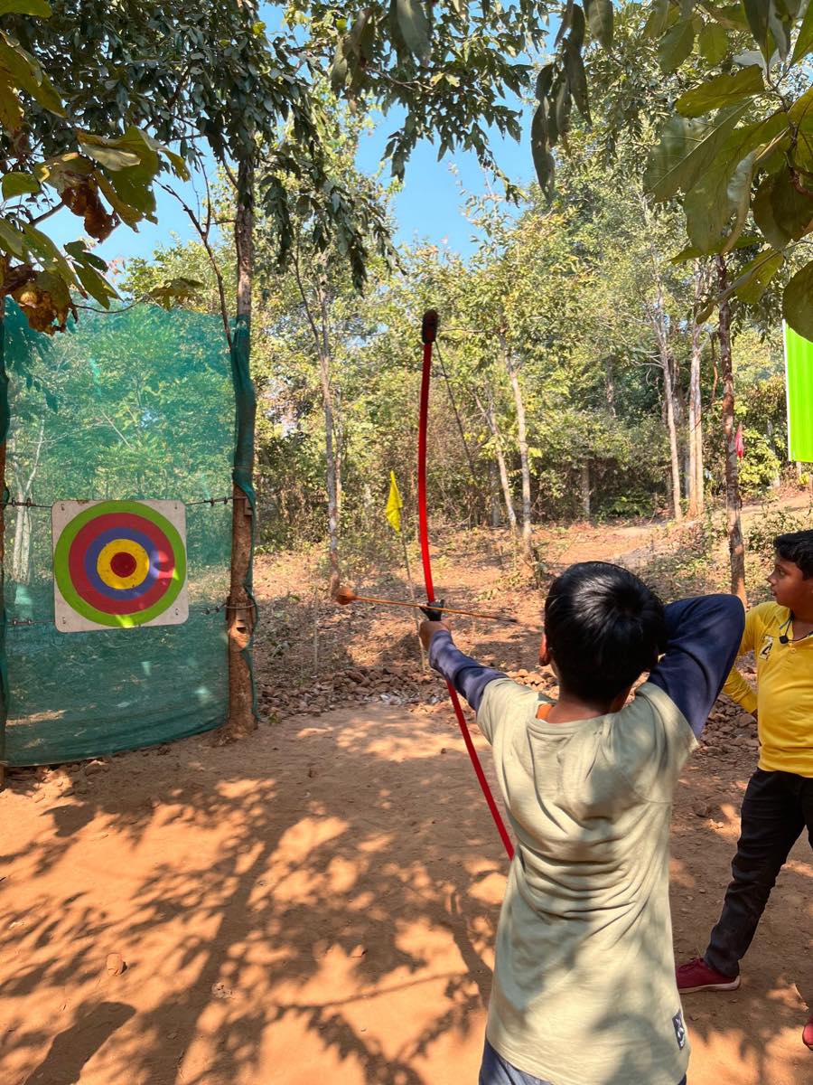 Archer loosing an arrow towards the target on an outdoor range