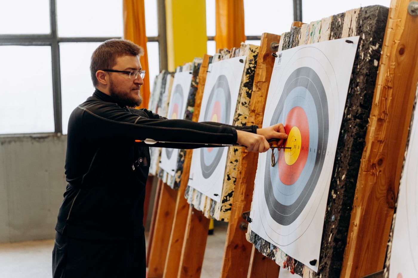 Archer at the target on an indoor range